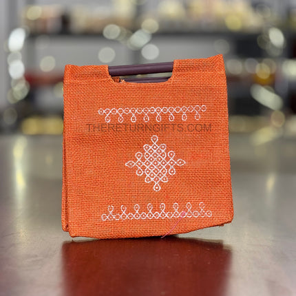 Orange Kolam Jute Bag with Wooden Handle Return Gift | TRG0110 | Handcrafted Kolam Print Jute Tote Under ₹100 | Traditional Wedding, Navratri & Pooja Favor Bag