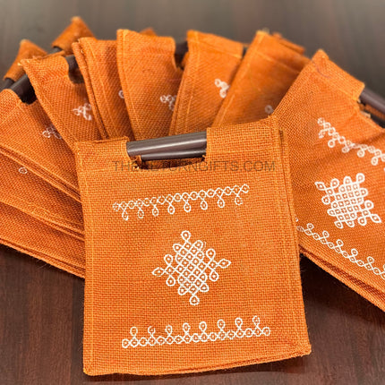 Orange Kolam Jute Bag with Wooden Handle Return Gift | TRG0110 | Handcrafted Kolam Print Jute Tote Under ₹100 | Traditional Wedding, Navratri & Pooja Favor Bag