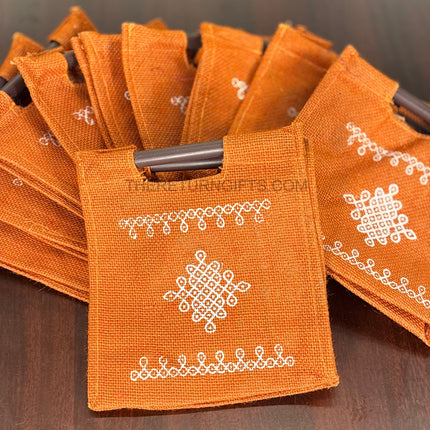 Orange Kolam Jute Bag with Wooden Handle Return Gift | TRG0110 | Handcrafted Kolam Print Jute Tote Under ₹100 | Traditional Wedding, Navratri & Pooja Favor Bag