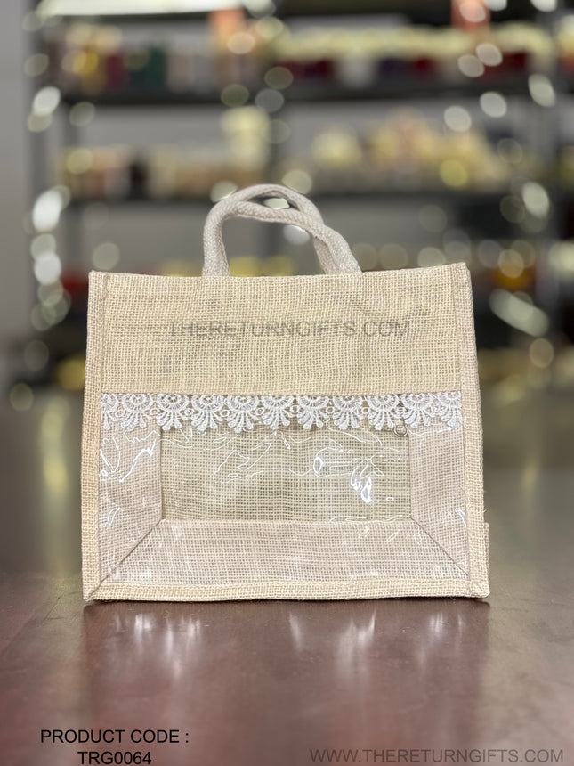 Beige Medium Jute Bag with Transparent Window | TRG0064 | Medium Jute Gift Bag with White Lace Handle | Eco‑Friendly Wedding & Housewarming Favor Under ₹150