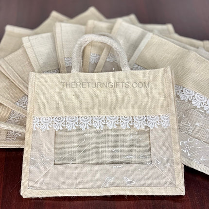 Beige Medium Jute Bag with Transparent Window | TRG0064 | Medium Jute Gift Bag with White Lace Handle | Eco‑Friendly Wedding & Housewarming Favor Under ₹150